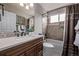 This bathroom boasts a tub, modern countertop, and decorative mirror at 14713 Josephine St, Thornton, CO 80602