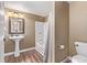 The bathroom features a classic pedestal sink and a combined tub and shower with neutral tones at 14713 Josephine St, Thornton, CO 80602