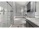 Well-lit bathroom with a glass shower, tub, and stylish vanity at 14713 Josephine St, Thornton, CO 80602