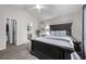 This bedroom features a doorway to the bathroom, gray carpet, and a stylish mirror at 14713 Josephine St, Thornton, CO 80602