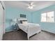 This bedroom features light blue walls, carpet flooring, and natural light at 14713 Josephine St, Thornton, CO 80602