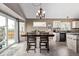 Cozy dining area featuring a chandelier, seamlessly connected to the kitchen with backyard views at 14713 Josephine St, Thornton, CO 80602