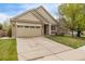 Beautiful home showcasing a two-car garage, well-maintained lawn, and inviting facade with a brick and siding exterior at 14713 Josephine St, Thornton, CO 80602