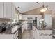 Updated kitchen features granite countertops, stainless steel appliances, and ample cabinet space at 14713 Josephine St, Thornton, CO 80602