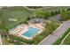 Aerial view of a community swimming pool with an adjacent recreation center, parking, and landscaping at 14713 Josephine St, Thornton, CO 80602