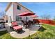 Backyard patio with outdoor furniture, grill and well manicured lawn perfect for outdoor living and entertainment at 4056 Perth St, Denver, CO 80249