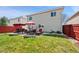 Large backyard with patio, outdoor furniture, and privacy fence great for entertaining and relaxation at 4056 Perth St, Denver, CO 80249