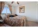 Cozy bedroom features a comfortable bed, ceiling fan, plush carpet and plenty of natural light from the window at 4056 Perth St, Denver, CO 80249