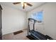 Bright bedroom with a ceiling fan, plush carpet, and a large window looking out to the backyard at 4056 Perth St, Denver, CO 80249