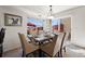 The formal dining room is complete with dining set and scenic outdoor views from the large bright windows at 4056 Perth St, Denver, CO 80249