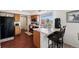 Kitchen featuring stainless steel appliances, wooden cabinets, bar seating and seamless flow to the dining area at 4056 Perth St, Denver, CO 80249