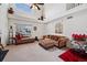 Cozy living room featuring high ceilings, a large window and plush seating, creating a perfect space to relax at 4056 Perth St, Denver, CO 80249