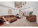 Bright living room boasts high ceilings, staircase, and plush seating, perfect for relaxing and entertaining at 4056 Perth St, Denver, CO 80249