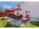 Inviting outdoor patio with red umbrellas, comfortable seating, and a relaxing lounge chair at 4056 Perth St, Denver, CO 80249