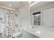 Clean bathroom featuring a shower with floral curtain and ample counter space at 1918 W 165Th Way, Broomfield, CO 80023