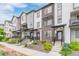 Street view of modern townhomes showcasing gray and white siding with brick accents and landscaped front yards at 1918 W 165Th Way, Broomfield, CO 80023
