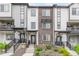 Modern townhome exterior showcasing gray and white siding with brick accents, complemented by well-maintained landscaping at 1918 W 165Th Way, Broomfield, CO 80023