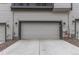 View of an attached two-car garage showing the exterior detailing and driveway at 1918 W 165Th Way, Broomfield, CO 80023