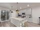 Modern kitchen featuring gray cabinets, stainless steel appliances, and a large island with pendant lighting at 1918 W 165Th Way, Broomfield, CO 80023