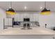 Bright kitchen showcasing a large island with a sink, modern fixtures, and stainless steel appliances at 1918 W 165Th Way, Broomfield, CO 80023