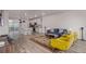 Open-concept living room with hardwood floors, bright seating, and seamless flow to the kitchen area at 1918 W 165Th Way, Broomfield, CO 80023