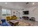 Modern living room showcasing hardwood floors, vibrant furniture, and sleek entertainment center at 1918 W 165Th Way, Broomfield, CO 80023