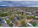 Wide aerial shot of neighborhood with lush trees under a dramatic sky at 6260 Lamar St, Arvada, CO 80003