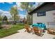 Backyard featuring a stone patio with comfortable seating options, swing set and fire pit at 6260 Lamar St, Arvada, CO 80003