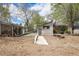 Picturesque backyard view showcasing a unique outbuilding, lush trees, and serene landscaping at 6260 Lamar St, Arvada, CO 80003