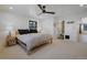 A calming bedroom featuring a wood frame bed, gray bedding and an ensuite door, offering privacy and convenience at 6260 Lamar St, Arvada, CO 80003