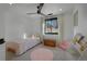 Cozy bedroom with a twin bed, a ceiling fan, and a pink rug, creating a warm and inviting space at 6260 Lamar St, Arvada, CO 80003