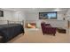 Cozy basement bedroom featuring a comfortable bed, sitting area, and ample natural light at 6260 Lamar St, Arvada, CO 80003