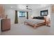 Spacious bedroom with a ceiling fan, two windows and white walls, offering a bright and airy feel at 6260 Lamar St, Arvada, CO 80003