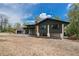 Modern home with a dark exterior and well-manicured lawn at 6260 Lamar St, Arvada, CO 80003