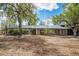 Expansive home exterior with multiple windows, mature trees and a well-maintained landscape at 6260 Lamar St, Arvada, CO 80003