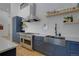 Stylish kitchen with a stainless steel farmhouse sink and modern appliances at 6260 Lamar St, Arvada, CO 80003