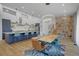Open-concept kitchen and dining area featuring a large island and stone accent wall at 6260 Lamar St, Arvada, CO 80003
