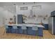 Spacious kitchen with a large island, modern appliances, and plenty of natural light at 6260 Lamar St, Arvada, CO 80003