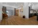 Bright and airy living room with access to a pool, featuring bookshelves, a modern kitchen, and hardwood floors at 6260 Lamar St, Arvada, CO 80003