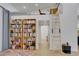 Living room featuring floor-to-ceiling bookshelves, a wooden ladder, and a cozy reading nook at 6260 Lamar St, Arvada, CO 80003