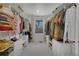 Well-organized walk-in closet with custom shelving, ample storage and a window allowing natural light at 6260 Lamar St, Arvada, CO 80003