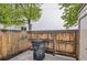 Wooden fenced backyard with a gate, leading to a large trash container at 1811 S Quebec Way # 31, Denver, CO 80231