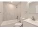 Modern bathroom features a tub-shower, marbled tile, and updated vanity with sink at 1811 S Quebec Way # 31, Denver, CO 80231