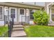 Inviting front entrance with steps, railing, and manicured lawn at 1811 S Quebec Way # 31, Denver, CO 80231