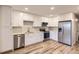 Well-lit kitchen with stainless steel appliances, white cabinetry, and modern countertops at 1811 S Quebec Way # 31, Denver, CO 80231