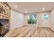 Comfortable living room boasts wood floors and a stone fireplace, enhancing the inviting atmosphere at 1811 S Quebec Way # 31, Denver, CO 80231