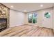 Inviting living room features wood floors, and a stone fireplace, creating a cozy and stylish ambiance at 1811 S Quebec Way # 31, Denver, CO 80231