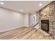 Bright living area featuring wood floors and a stone fireplace with metallic doors at 1811 S Quebec Way # 31, Denver, CO 80231