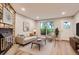 Bright living room with modern furnishings, wood floors, and a stone fireplace at 1811 S Quebec Way # 31, Denver, CO 80231