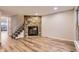 Spacious living area with wood floors and a stone fireplace at 1811 S Quebec Way # 31, Denver, CO 80231